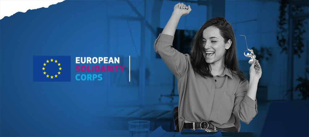 Baner European Solidarity Corps. Kobieta ciesząca się na niebieskim tle.